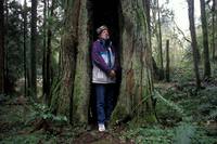 Dale Gilsdorf meditates in the burned out trunk of a cedar tree.