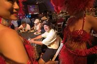 Golfers mingle with showgirls during dinner at the Casablanca Resort and Casino in Mequite, Nevada. Golfer Jason Rudquist<br/>of Phoenix was playing for $1 million as part of the Big Stakes Golf Tournament.
