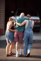 Nicolle and Bonnie help Dale, who was disoriented and agitated as they attempted to go<br/>on an ice cream outing in mid-September. It took an hour to actually get in the car.