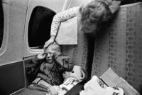 Half way through his all-night flight, Sergei is frightened and feels alone. Hearing his<br/>muffled cries, Tatiana Khokorina woke to comfort the little boy.