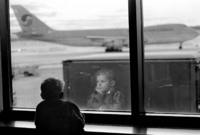 Sergei stares out at the Anchorage Airport, exhausted after his<br/>7-hour flight from Russia and still facing a long flight to Seattle.