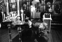 At the Russian Orthodox Church in Seattle, Sergei lights a prayer candle. His mother is a faithful member of the church<br/>in Sovetskaya Gavan, but Sergei has rarely attended and is ignorant of the rituals.