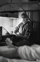 In the pre-dawn hours, nurse Shirley Moore keeps vigil over a patient.