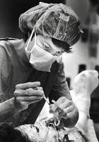 RN Jean Otto gives J. C. Gift medication through his feeding tube.