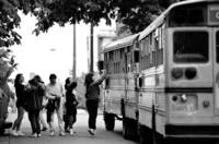 Parents jump and wave to their children, who are off on a great journey.